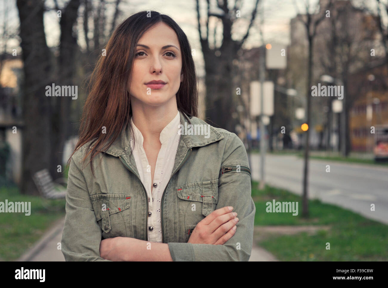 Portrait of a young confident woman on city street Stock Photo