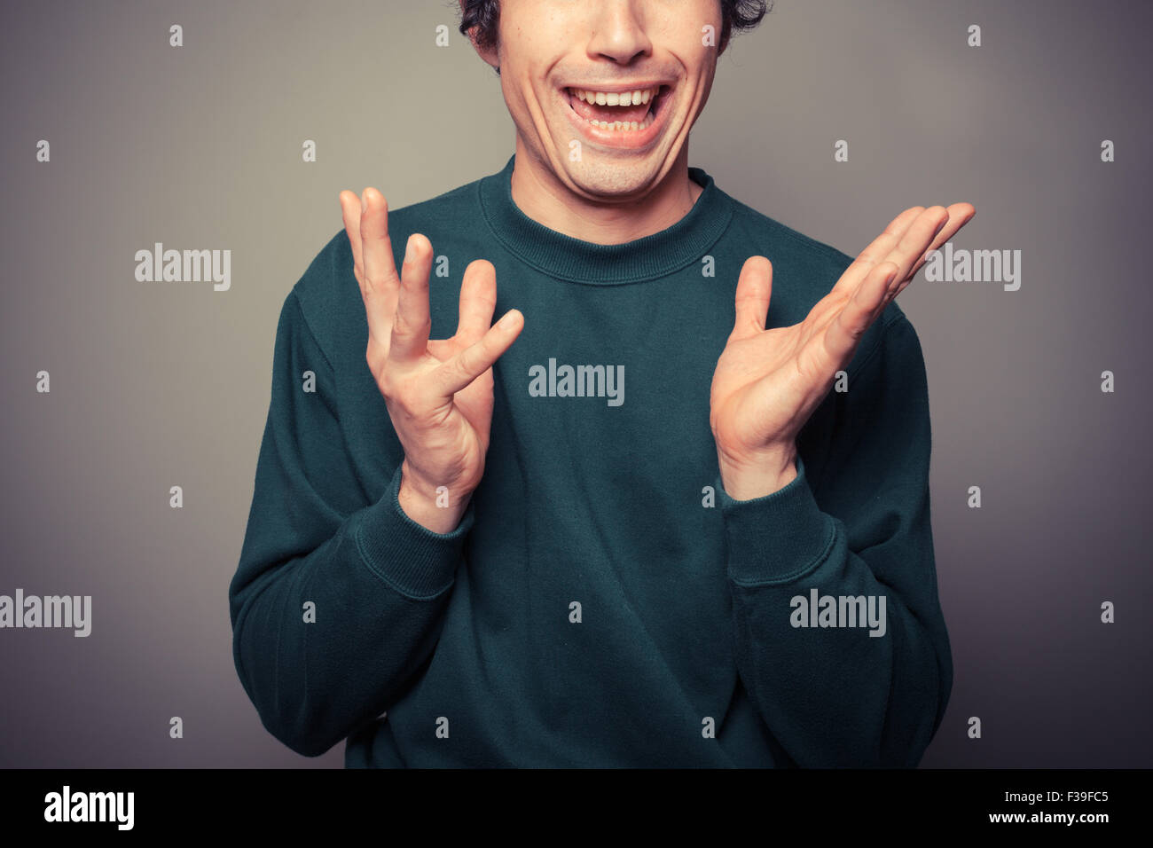 A young man is gesturing and pulling silly faces Stock Photo