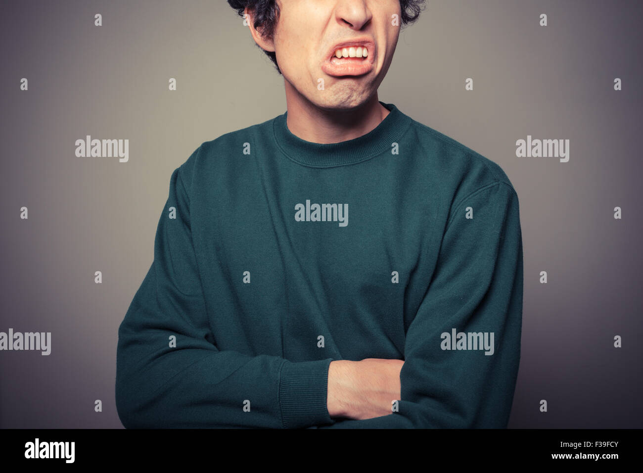 A young man is gesturing and pulling silly faces Stock Photo