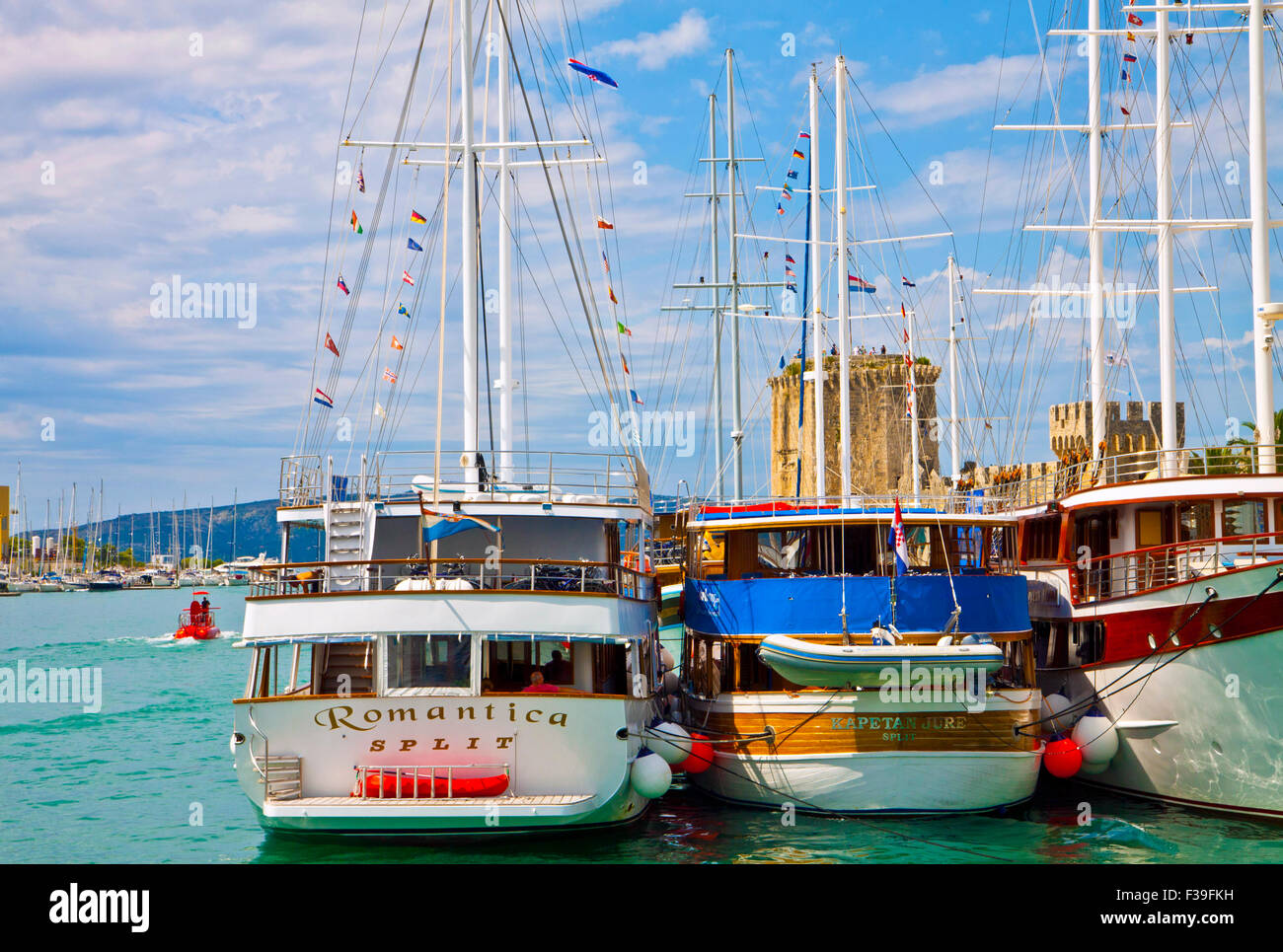 Trogir Croatia sea promenade with touristic cruise ships moored and Kamerlengo castle towers Stock Photo