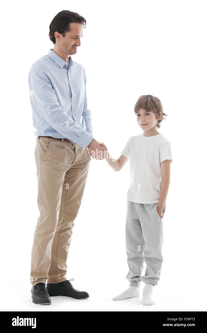 Cheerful father and son shaking hands isolated on white background