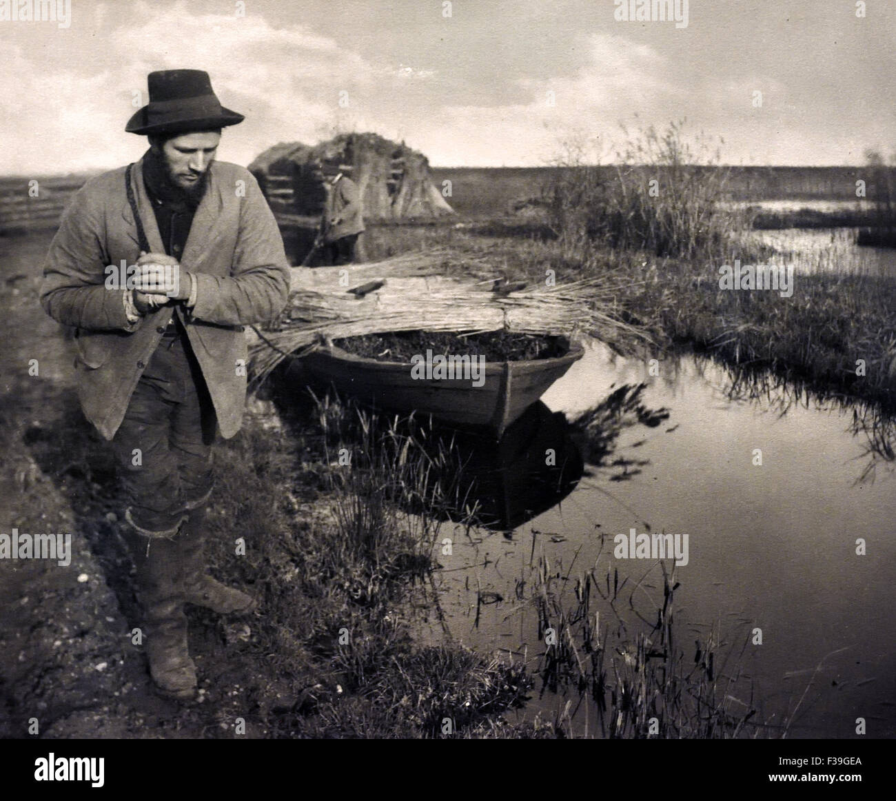 Towing the Reed by Boat 1885 Peter Henry Emerson 1856 - 1936 ( from: Life and Landscape on the Norfolk Broads1886  ) Stock Photo