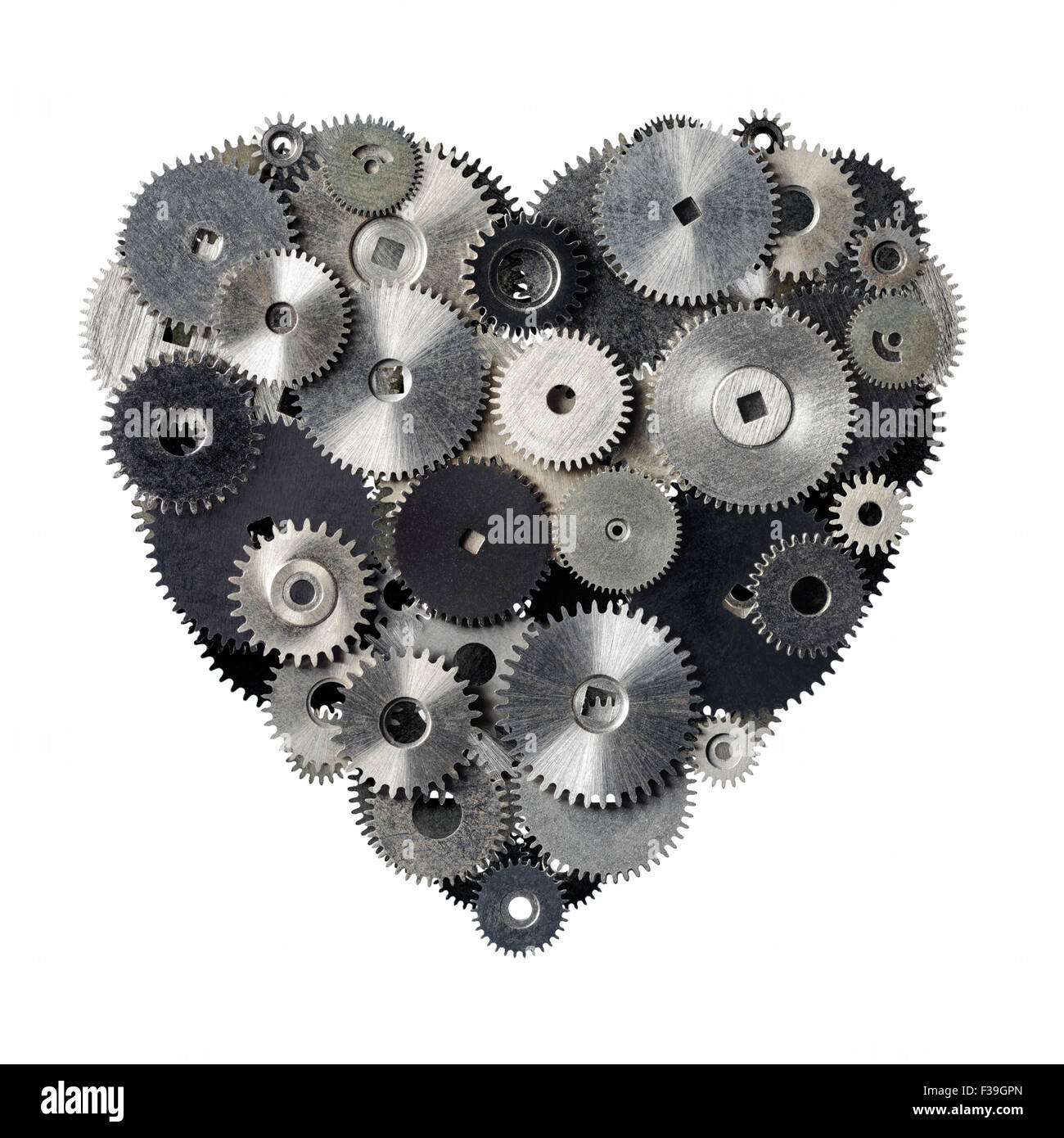 Isolated objects: heart shape made of metal pinions and sprockets, isolated on white background. Technical abstract for Valentin Stock Photo