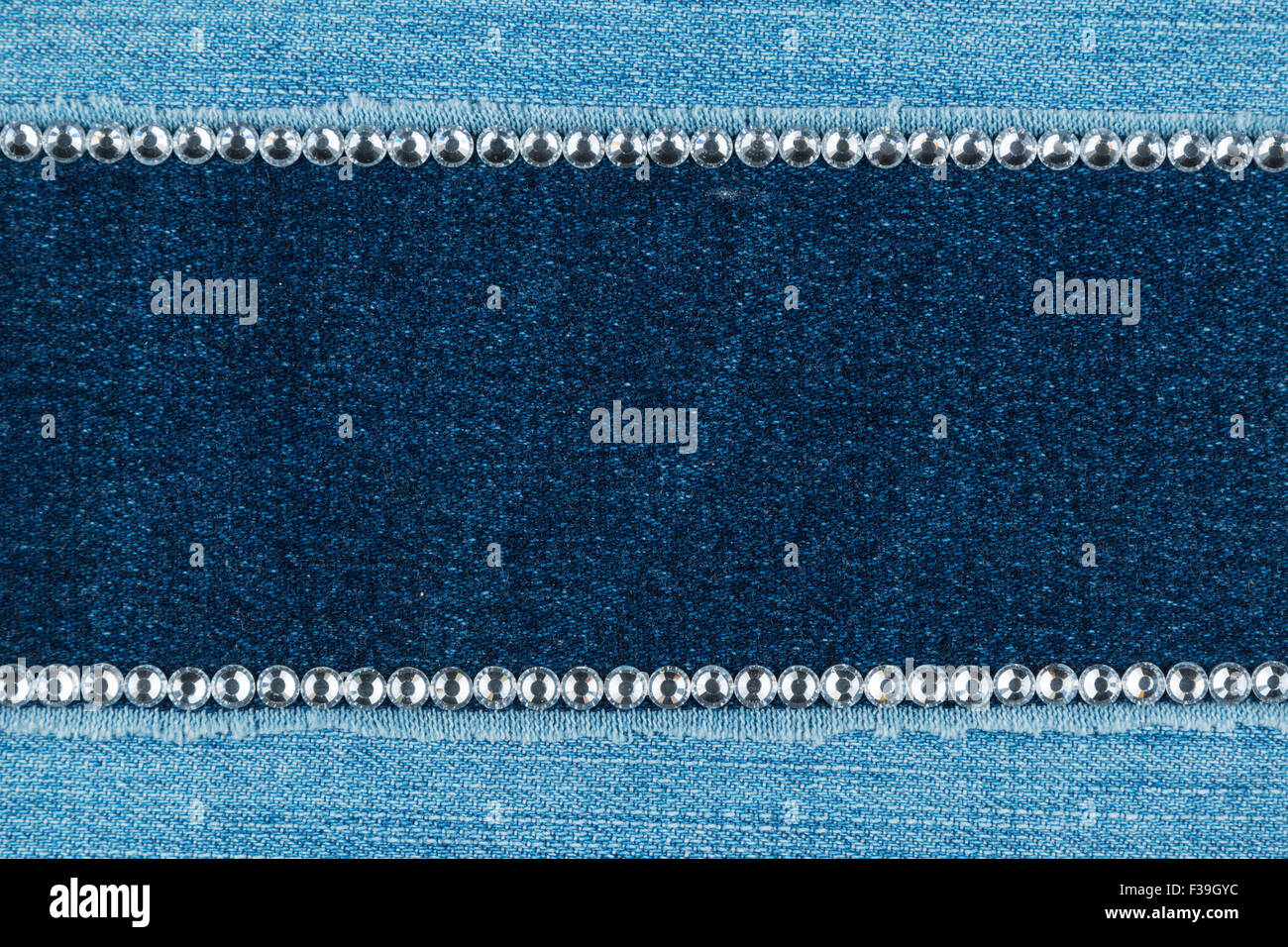 Fashionable background, jeans and silver rhinestones, with space for