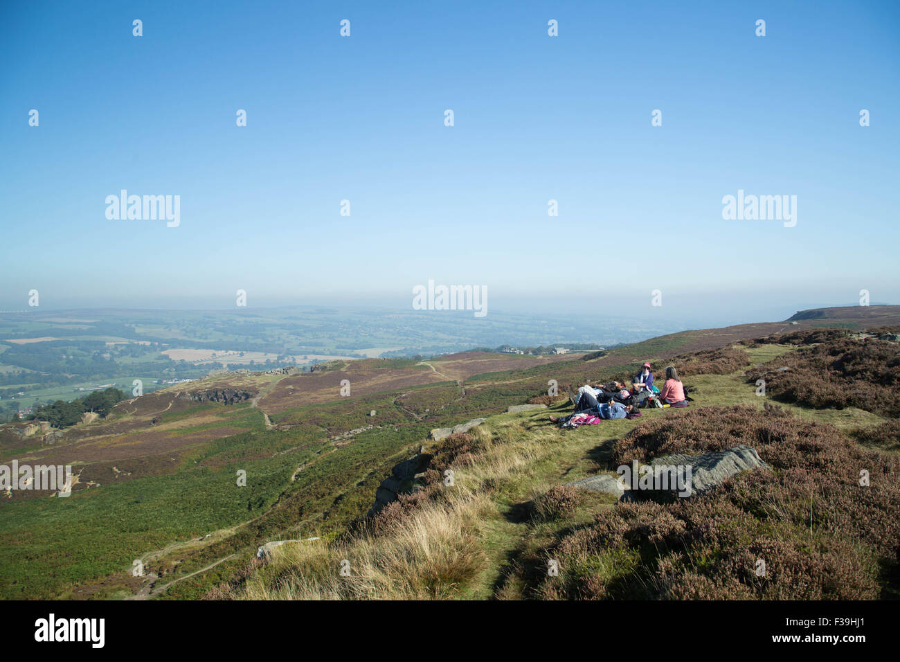 Ilkley Moor in West Yorkshire, UK. 2nd October 2015. UK Weather: Day trippers enjoy the beautiful autumn sunshine and fantastic views on top of Ilkley Moor in West Yorkshire, UK. 2nd October 2015. Forecaster have predicted that the country is to enjoy a last few days of warm, spring like, weather before things begin to turn wet and stormy next week.   Credit:  Ian Hinchliffe/Alamy Live News Stock Photo