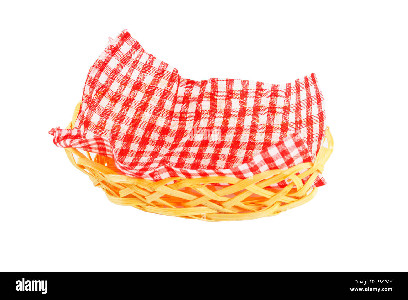 wicker basket with a checkered napkin isolated on white background ...