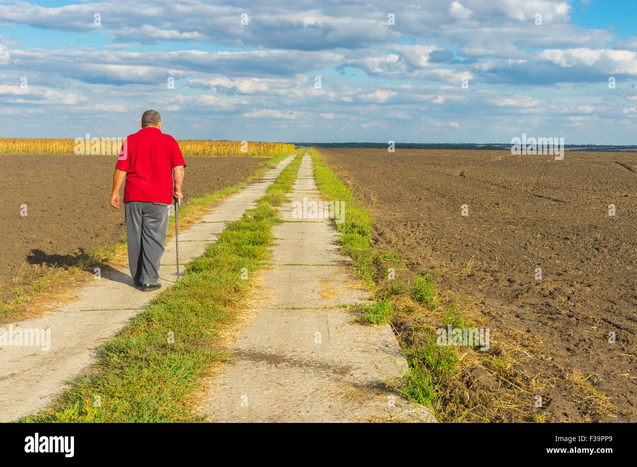 Old man walking stick road hi-res stock photography and images - Alamy