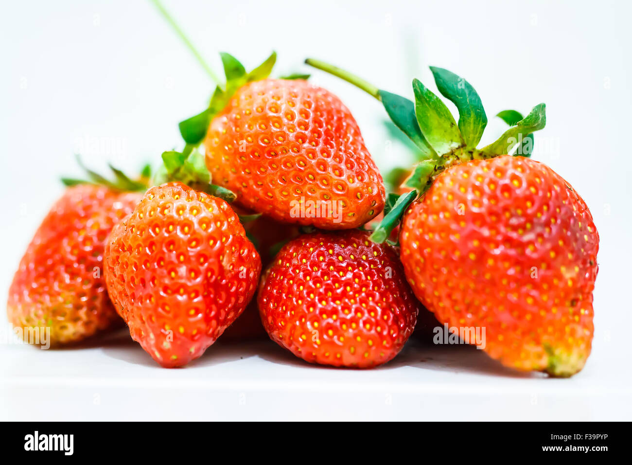 Strawberry berries on a white background Stock Photo - Alamy