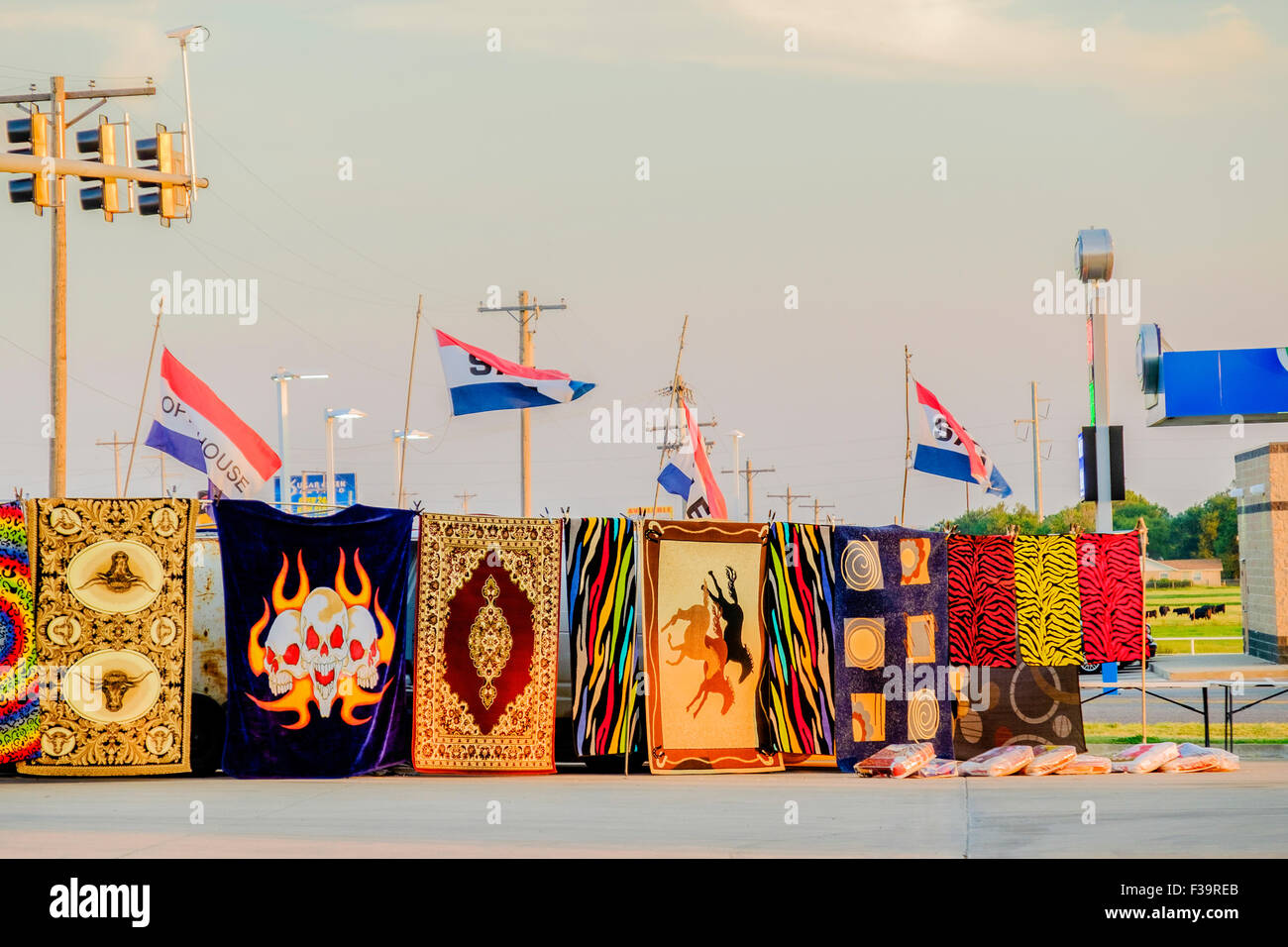 colorful rugs for sale displayed at the corner of a convenience store