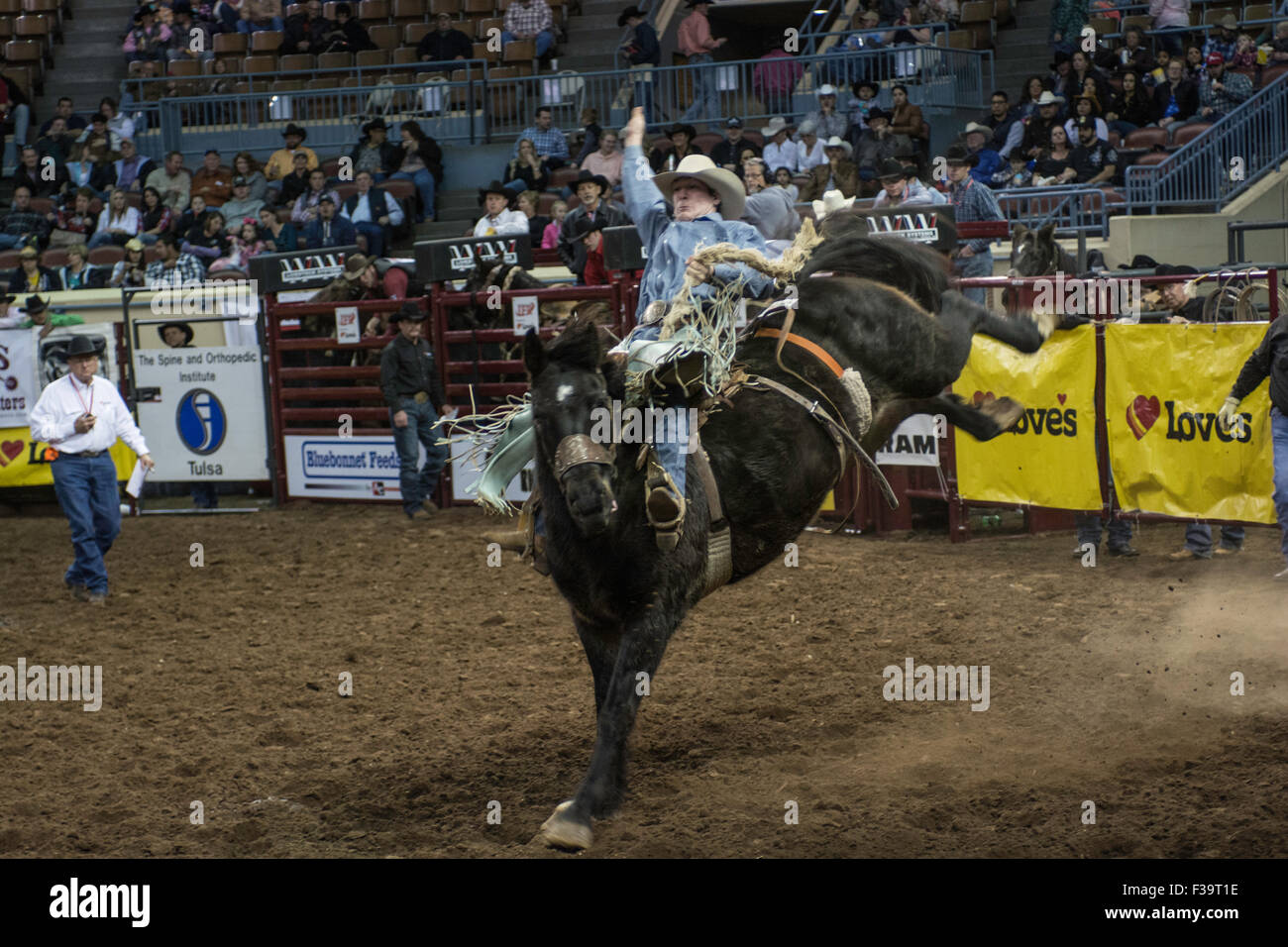 Cowboy riding bucking horse during rodeo in Oklahoma City, Oklahoma