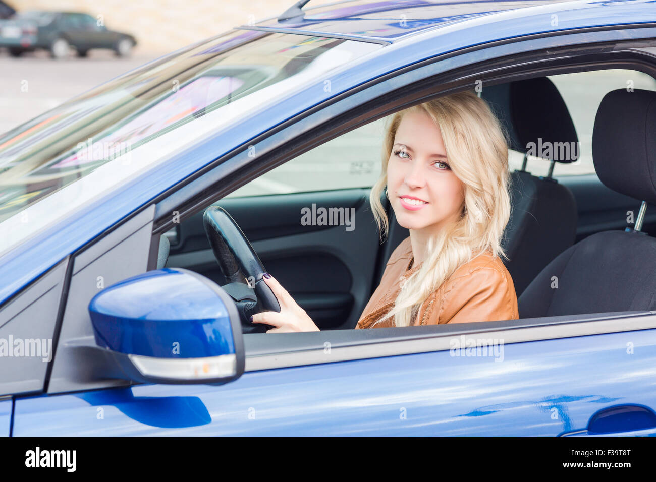 Beautiful happy young girl sitting in her car Stock Photo - Alamy
