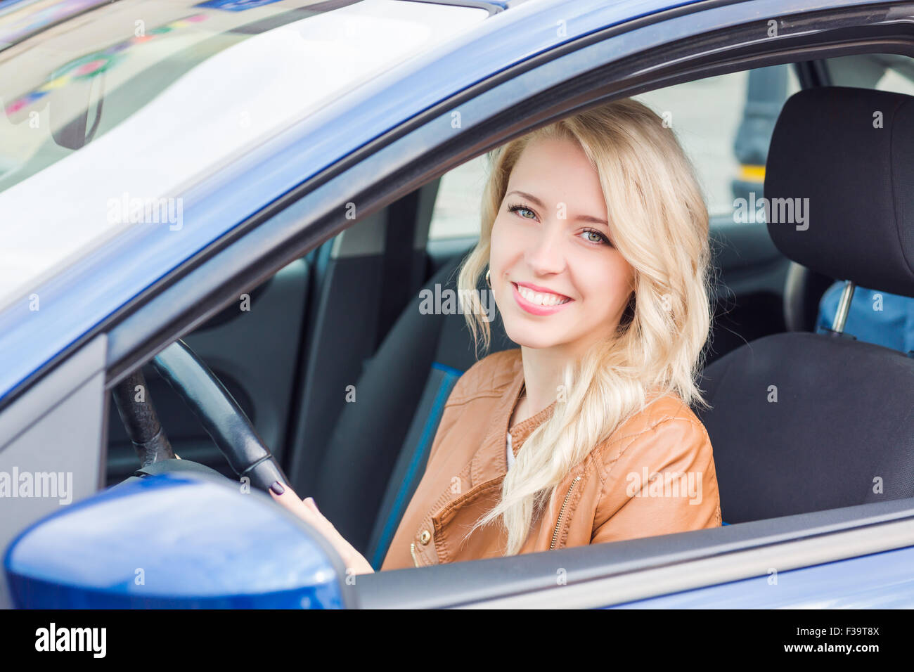Beautiful happy young girl sitting in her car Stock Photo - Alamy