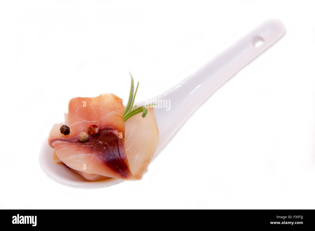 Smoked swordfish on teaspoon on white background Stock Photo