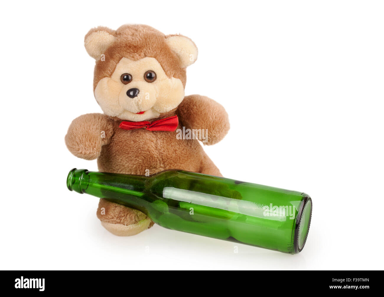 teddy bear and an empty bottle of beer isolated on white background Stock Photo