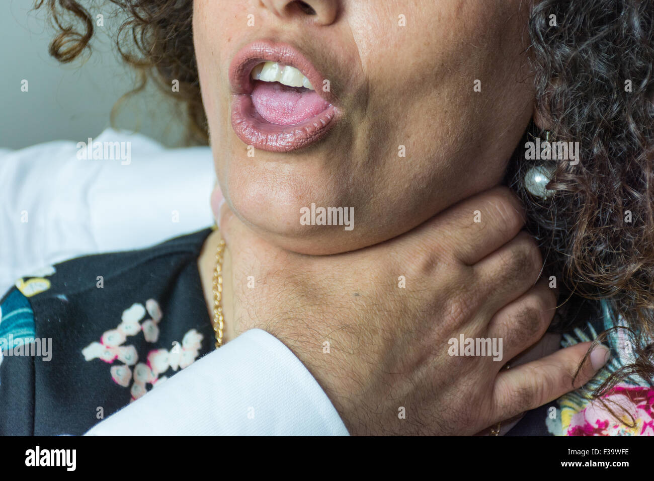 Domestic violence between man and woman, husband and wife, between lovers, between brother and sister. Colloe hands to his mouth Stock Photo