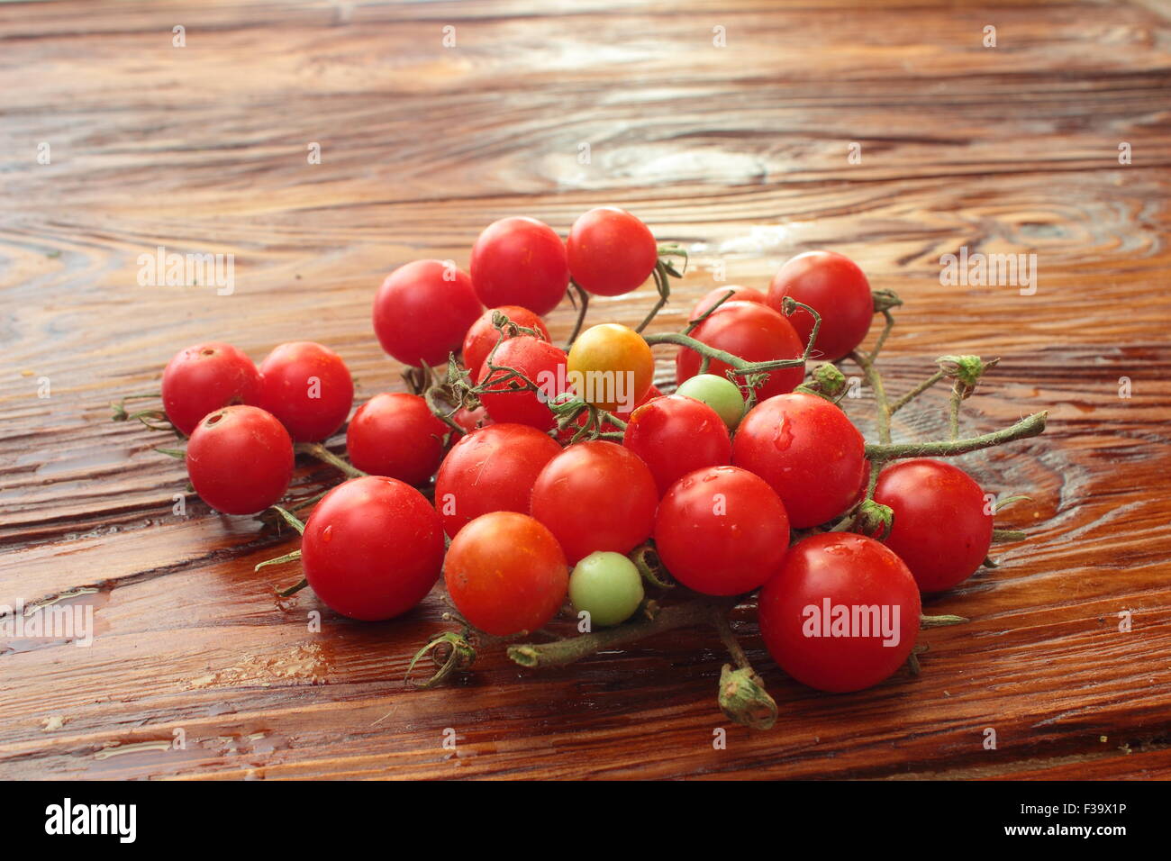 on a wooden board cherry tomatoes Stock Photo - Alamy