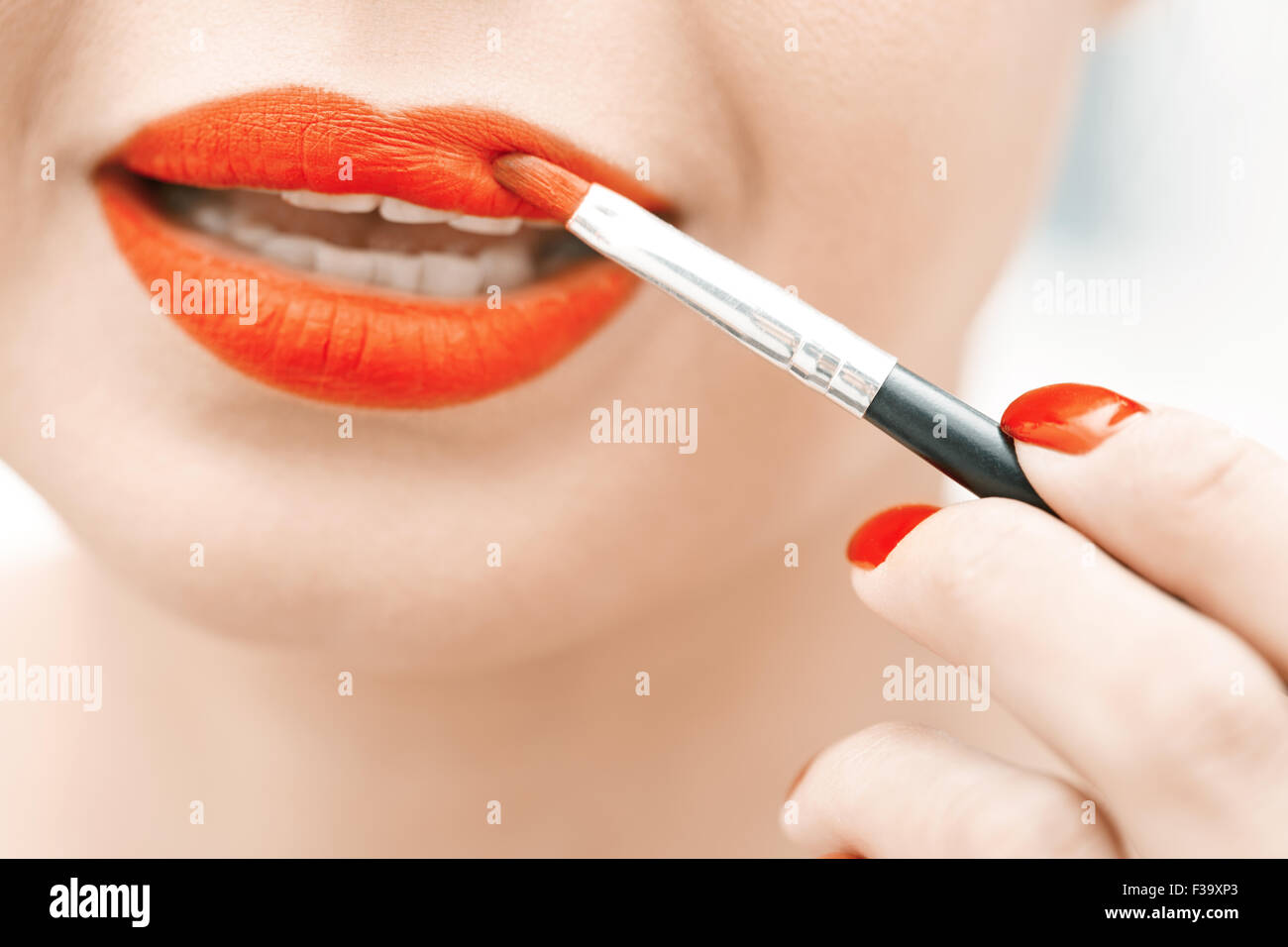 Woman applying red lipstick. Close-up view on face Stock Photo