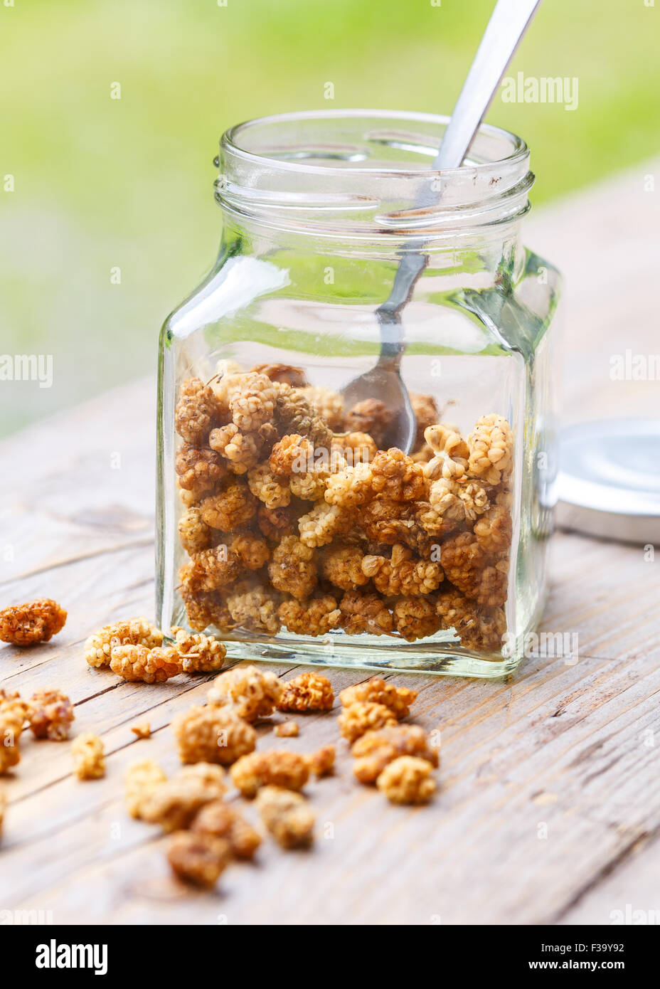 A jar of dried mulberries in a glass jar Stock Photo