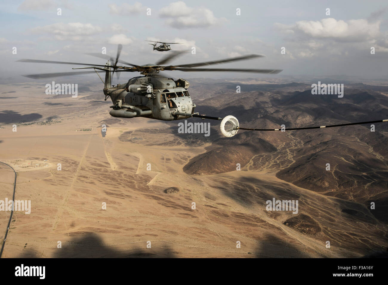 November 15, 2013 - A U.S. Marine Corps CH-53E Super Stallion prepares to refuel from a U.S. Air Force HC-130 during in-air refu Stock Photo
