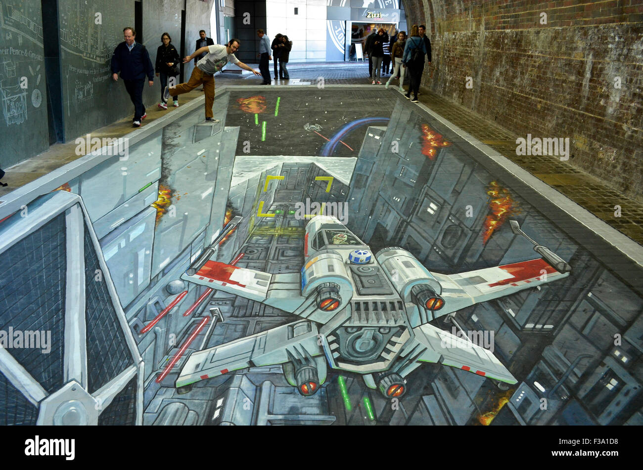 A 3-D Star Wars painting by Joe and Max which appeared in the pedestrian tunnel under Southwark Bridge, London, 1st-2nd October 2015, to coincide with the UK release of the Rise Against The Empire play set. The painting, which was 49 feet (15 metres) long, has both bemused wregular commuters and drawn crowds of tourists keen to see it throughout the two days, and shows the attack on the Death Star by Luke Skywalker's X-Wing with an Imperial TIE Fighter in pursuit to the left. Credit:  Antony Nettle/Alamy Live News Stock Photo