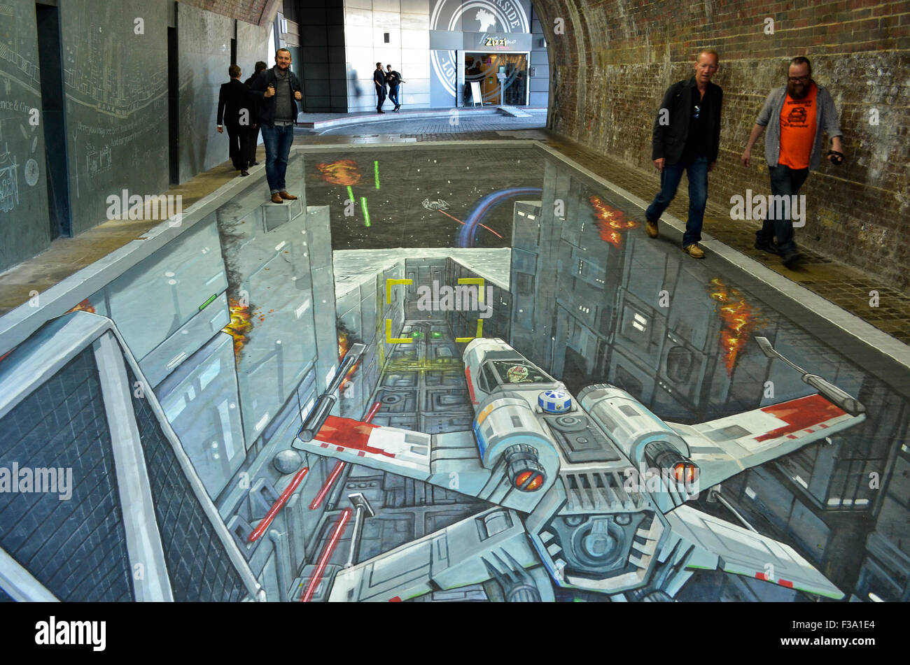 A 3-D Star Wars painting by Joe and Max which appeared in the pedestrian tunnel under Southwark Bridge, London, 1st-2nd October 2015, to coincide with the UK release of the Rise Against The Empire play set. The painting, which was 49 feet (15 metres) long, has both bemused wregular commuters and drawn crowds of tourists keen to see it throughout the two days, and shows the attack on the Death Star by Luke Skywalker's X-Wing with an Imperial TIE Fighter in pursuit to the left. Credit:  Antony Nettle/Alamy Live News Stock Photo