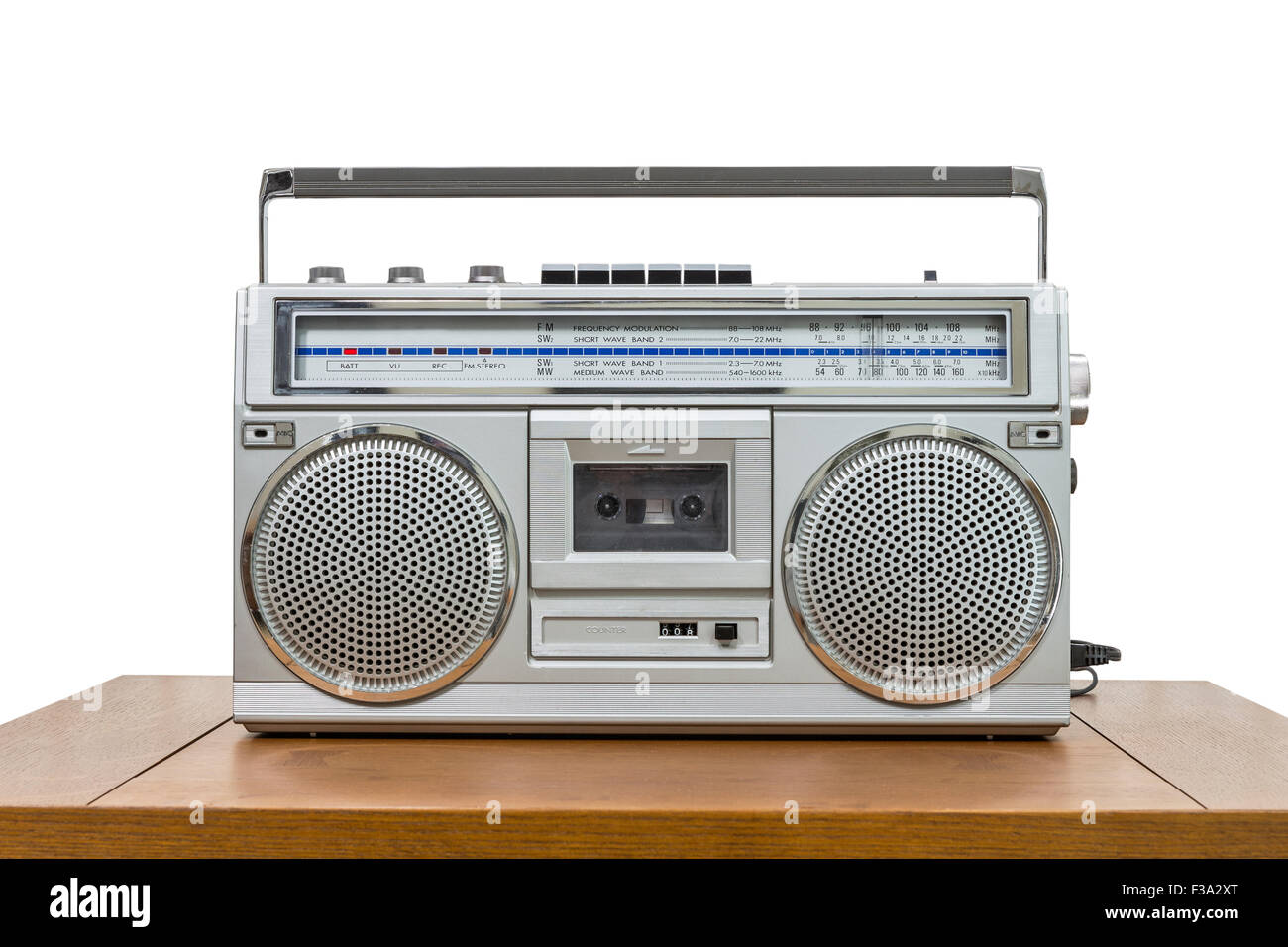 Vintage boombox on wood table isolated on white. Stock Photo