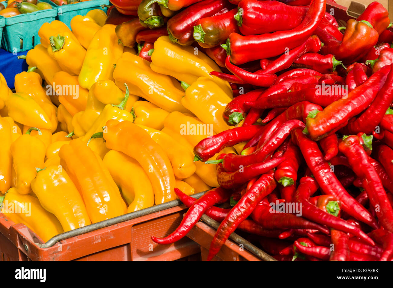 Red and yellow peppers on display at the market Stock Photo - Alamy