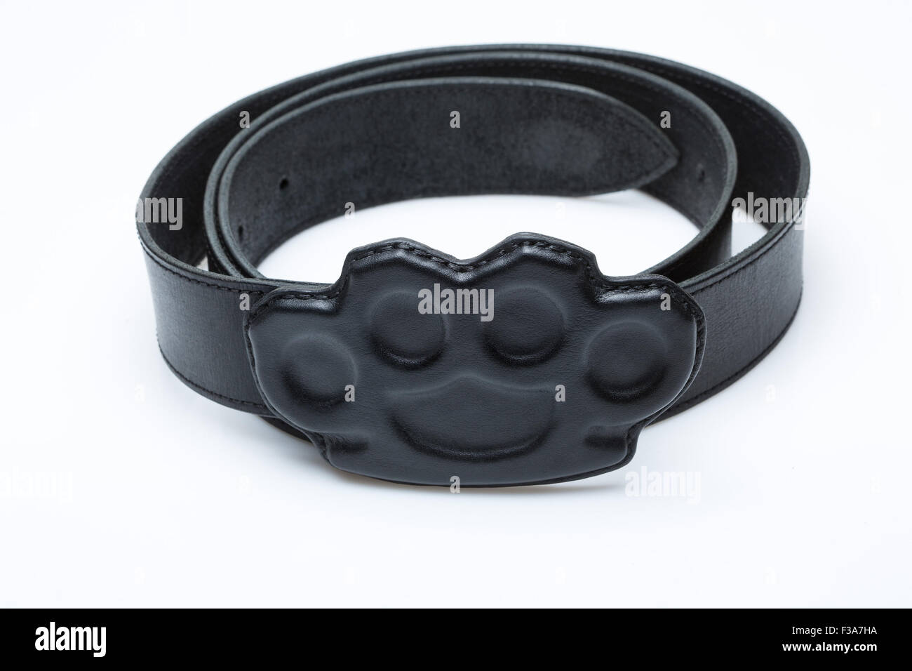 black belt with a buckle in the form of brass knuckles Stock Photo