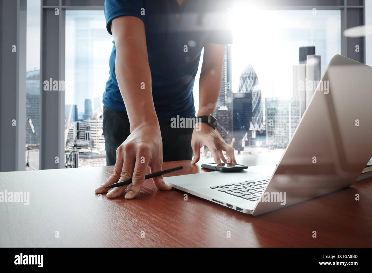 Young creative designer man working at office with computer laptop as ...