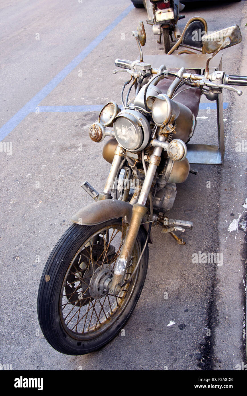 Rustic antique retro motorcycle on the street Stock Photo