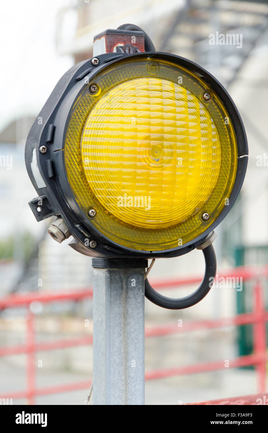 One yellow signal light on an urban background Stock Photo Alamy