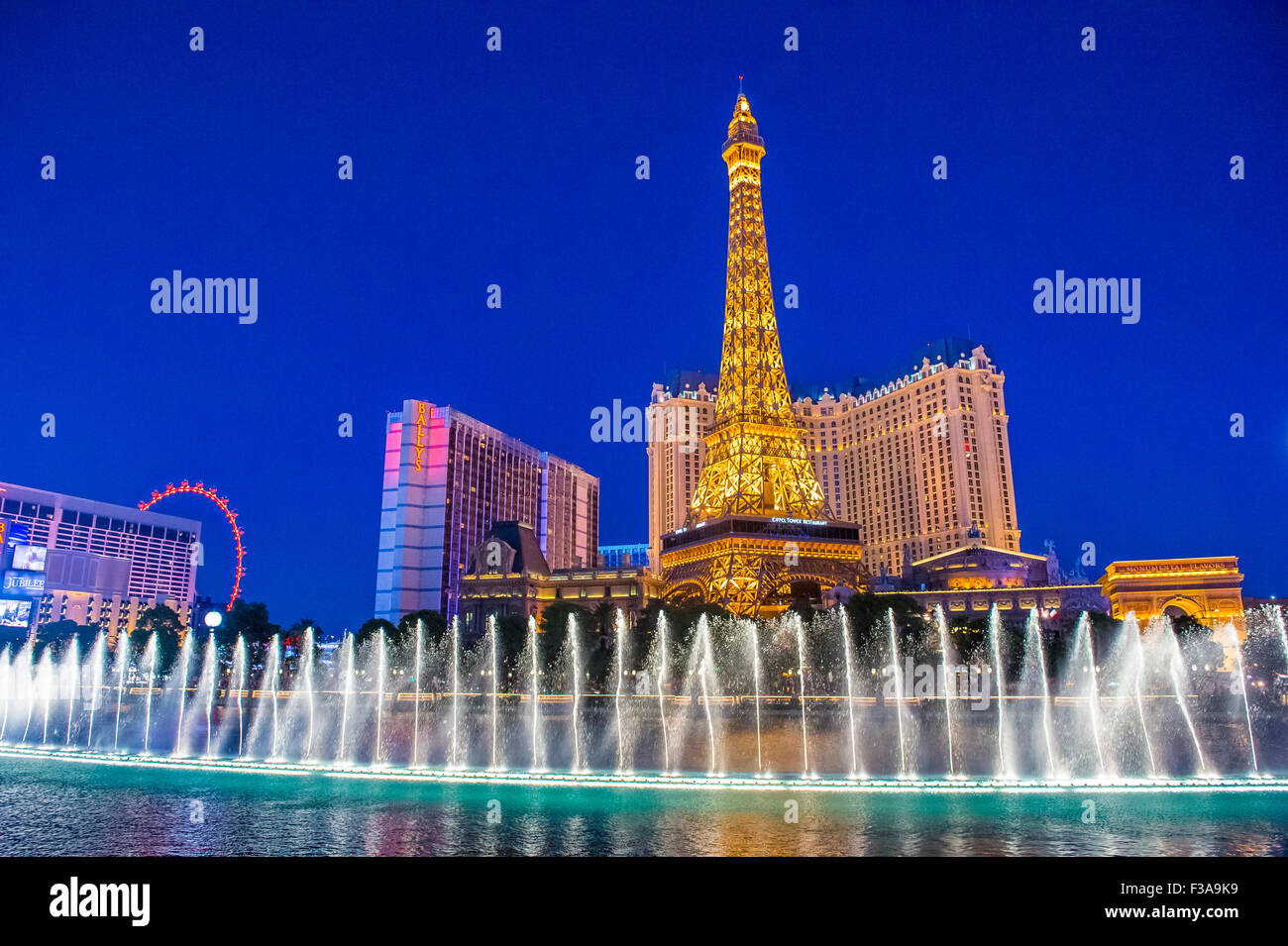 Night view of the dancing fountains of Bellagio and the Eiffel Tower