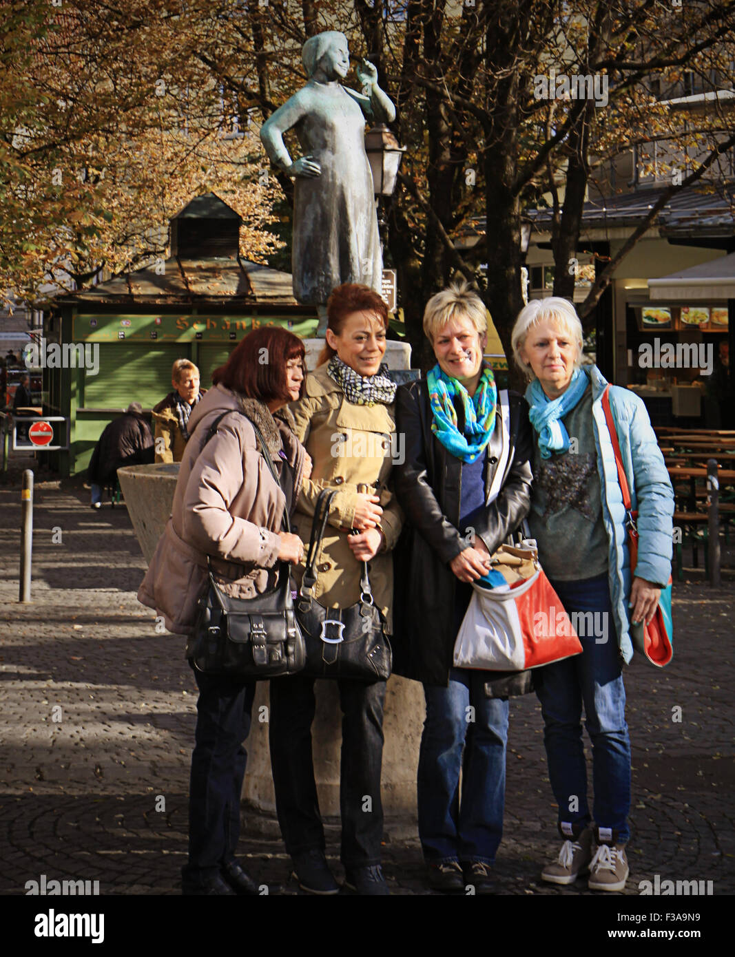 Munich,Germany - women  ready for a selfie, smile at the camera at Viktualienmarkt in Munich center Stock Photo
