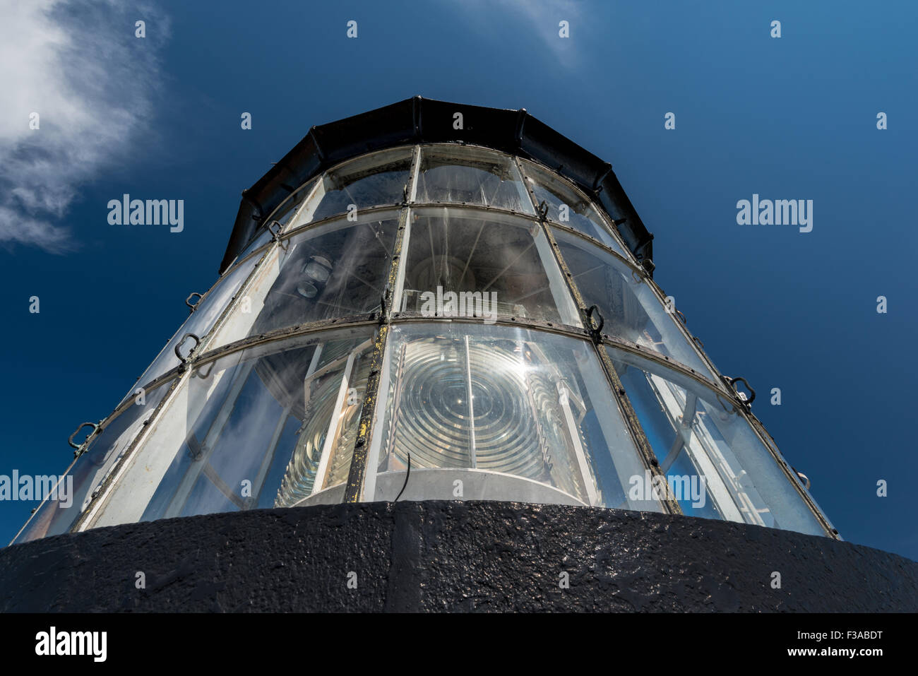 lighthouse light detail isolated on a blue and cloudy sky Stock Photo