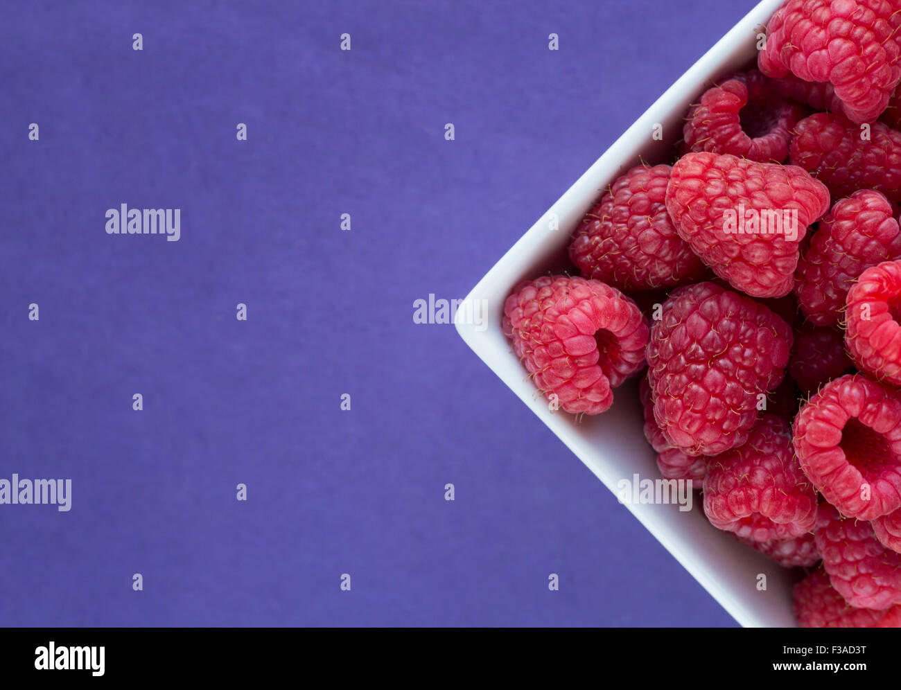 Raspberries in a bowl Stock Photo