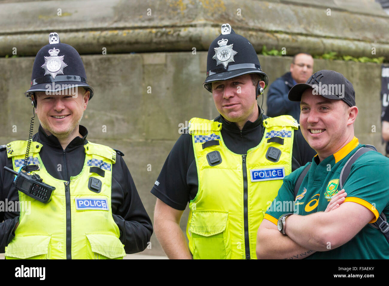 Newcastle upon Tyne, UK. 3rd October, 2015. A great atmosphere as fans gather in Newcastle city centre ahead of this afternoon`s game between South Africa and Scotland as fans gather in the city centre. PICTURED: A South Africa fan having photo taken with the local constabulary. Credit:  Alan Dawson News/Alamy Live News Stock Photo