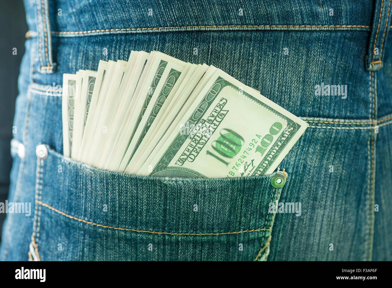 Back pocket containing 100 US dollar banknotes, close up. Stock Photo