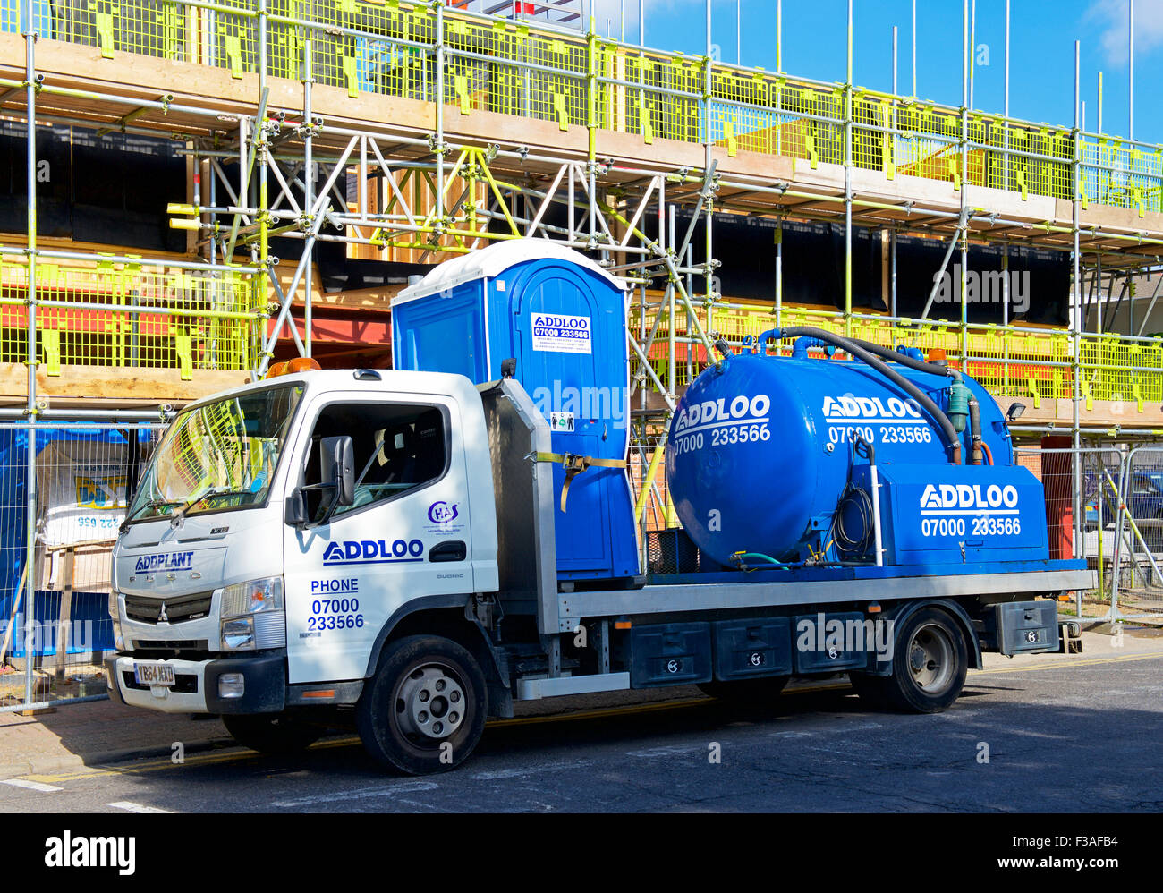 Lorry delivering portable toilet to building site, England UK Stock ...