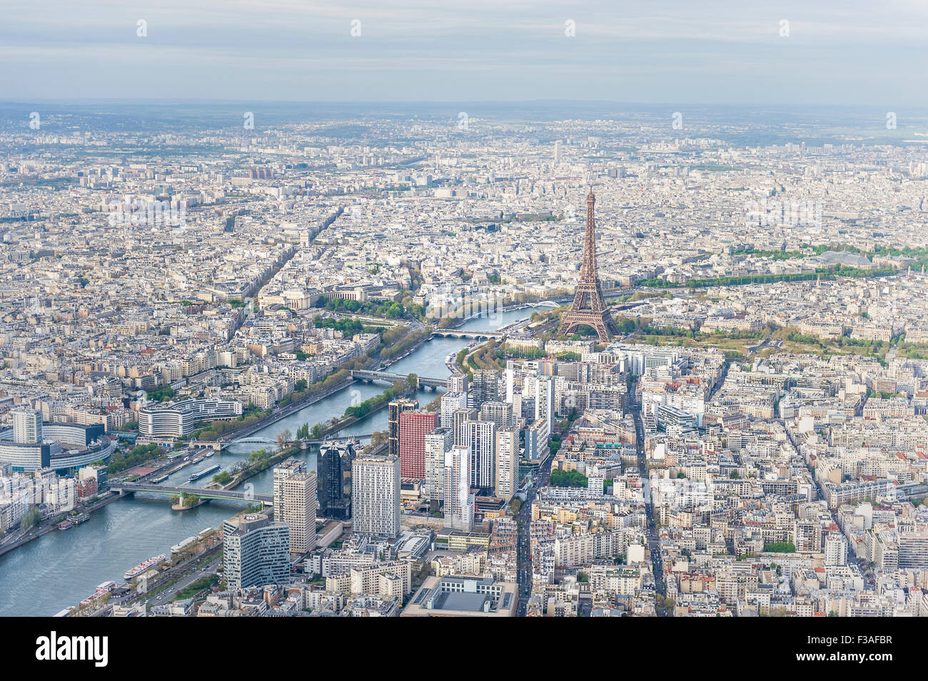 Aerial view of Paris city center with the Seine river and its bridges in the foreground and the Eiffel tower in the background. Stock Photo