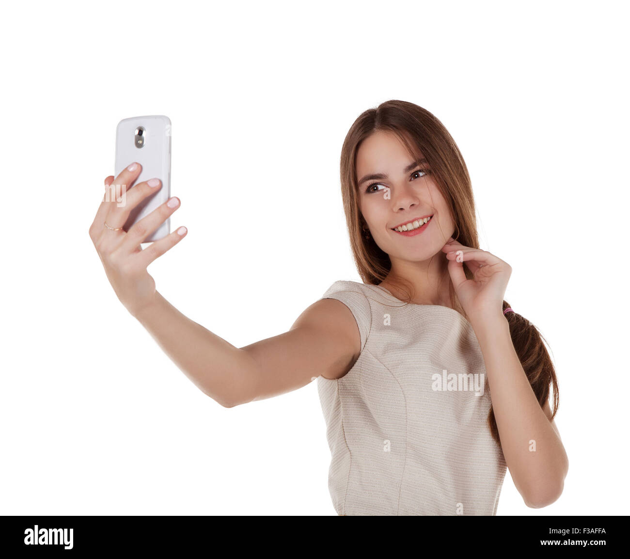 young pretty brunette girl in light dress photographing herself with mobile phone Stock Photo