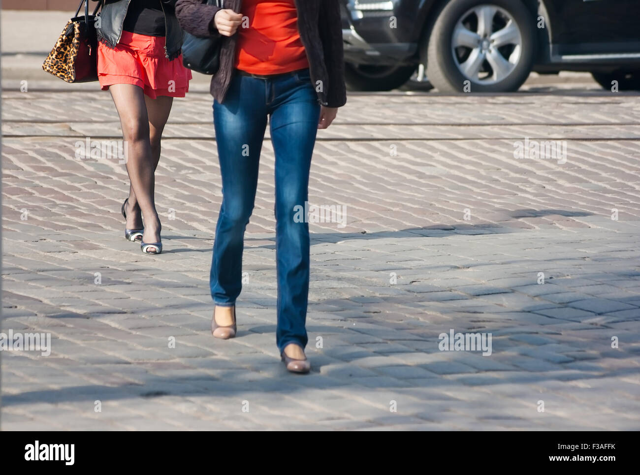 two women pedestrians crossing at a pedestrian crossing Stock Photo - Alamy