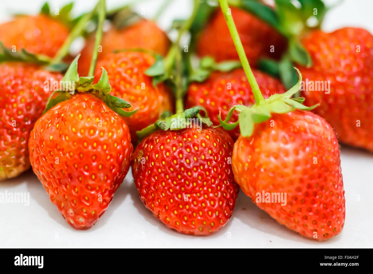 Strawberry berries on a white background Stock Photo - Alamy