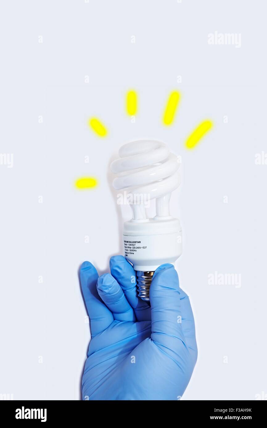 Hand Held CFL Spiral 13W 50W Watt Energy Saving Light Bulb E27 Stock Photo
