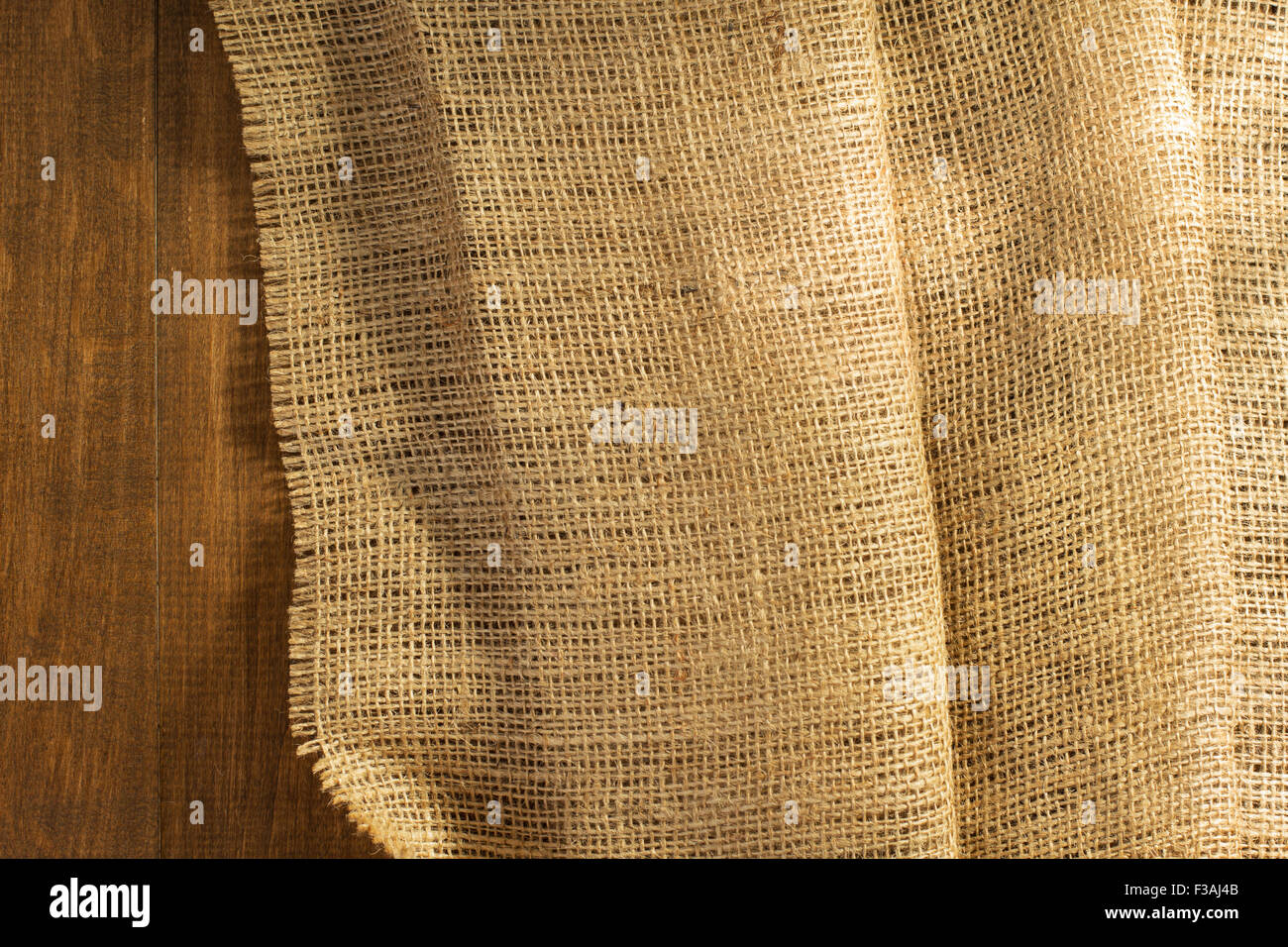 Sacking burlap hessian sacking on wooden background Stock Photo - Alamy