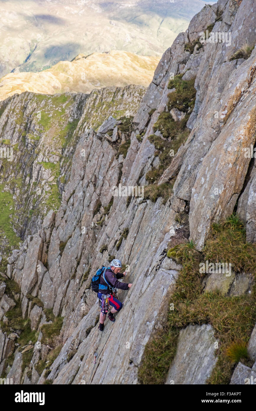 retired man rock climbing on Lliwedd, part of the Snowdon massif, Wales. The route is Avalanche/Red Wall/ Longlands Continuation Stock Photo