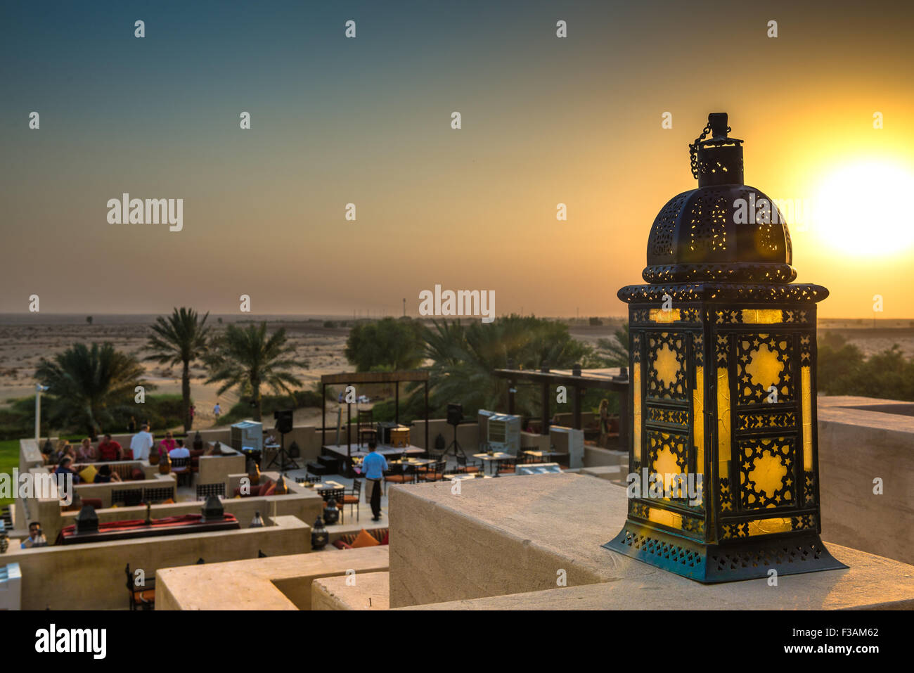 Sunset over the Dubai desert as seen from the Al Sarab rooftop lounge at the Bab Al Shams Resort Stock Photo