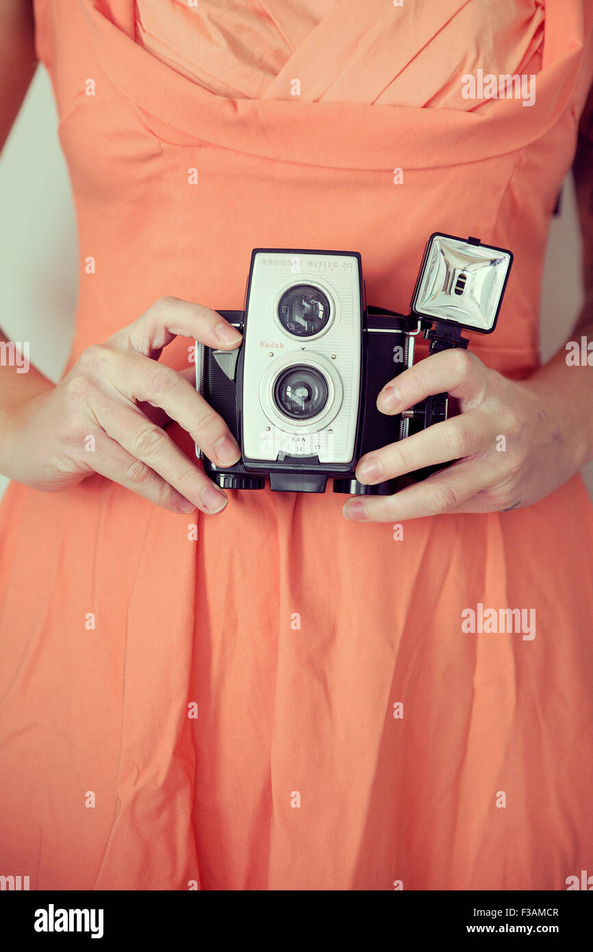 Young vintage woman holding a camera Stock Photo