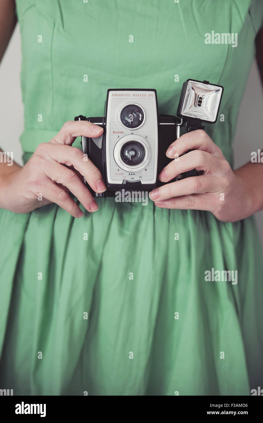 Vintage woman holding a vintage camera Stock Photo