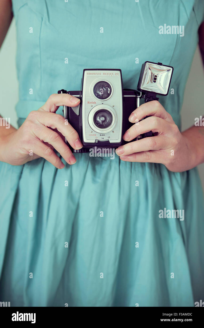 Vintage woman holding a vintage camera Stock Photo