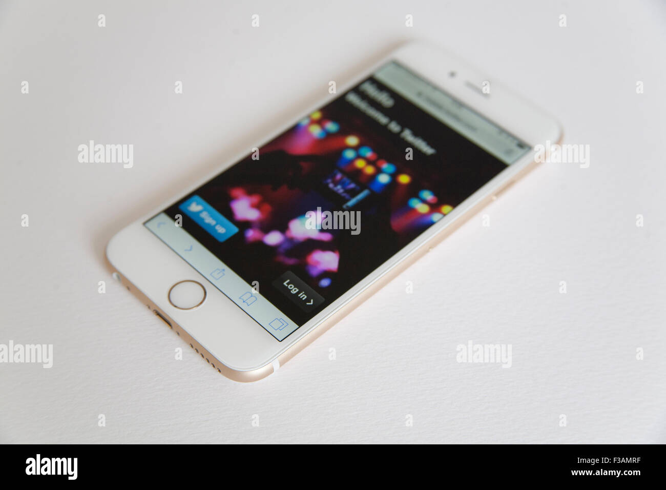 Gold and white Apple iPhone 6 with a Twitter log in page against a white background Stock Photo